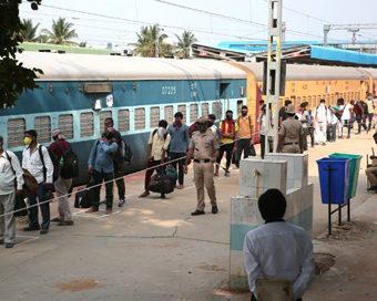 Bengaluru: Migrant workers wait in a queue to board a Shramik Special train to reach their native place in Uttar Pradesh at Chikkanbanavara railway, in Bengaluru on May 8, 2020. (Photo: IANS)